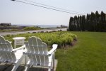 The front lawn with adirondack chairs and ocean views.